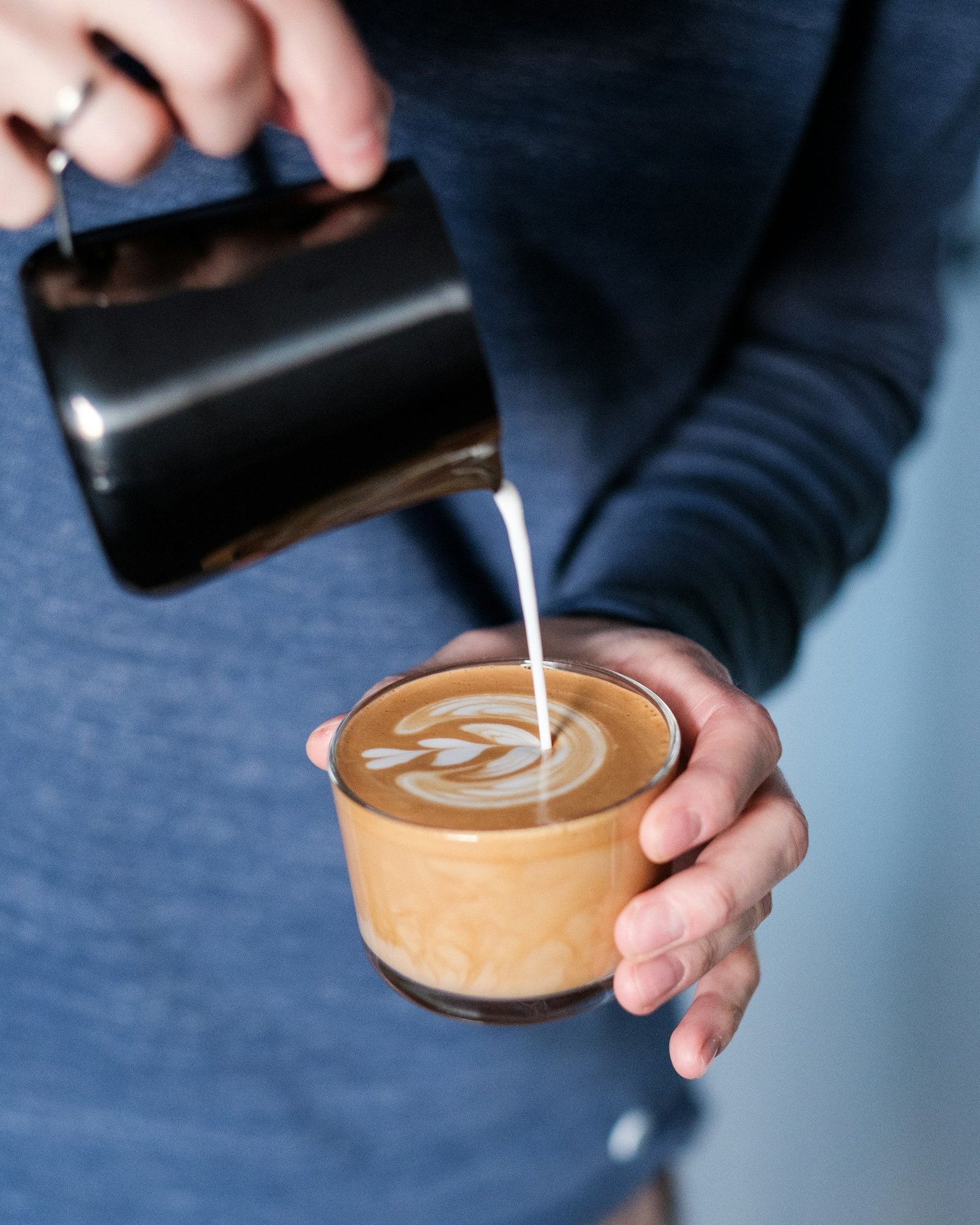 Barista pouring steamed milk at Cafe Brew Vibe