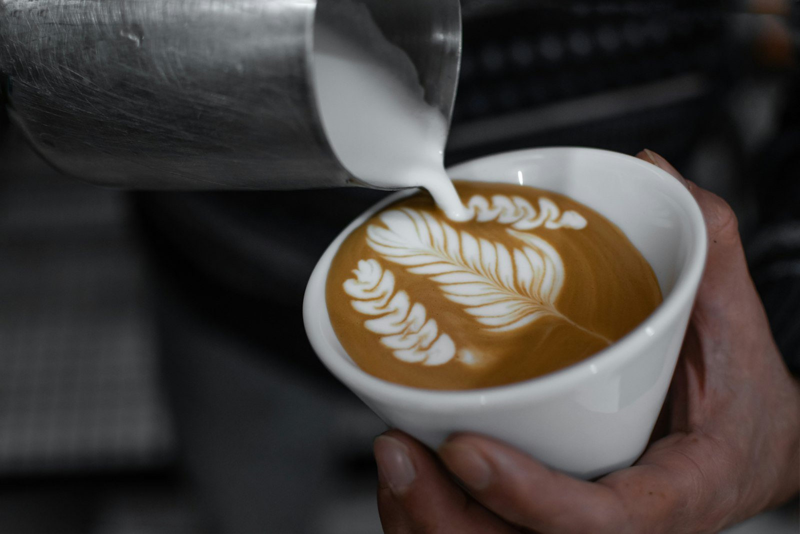 Close-up of latte art being poured